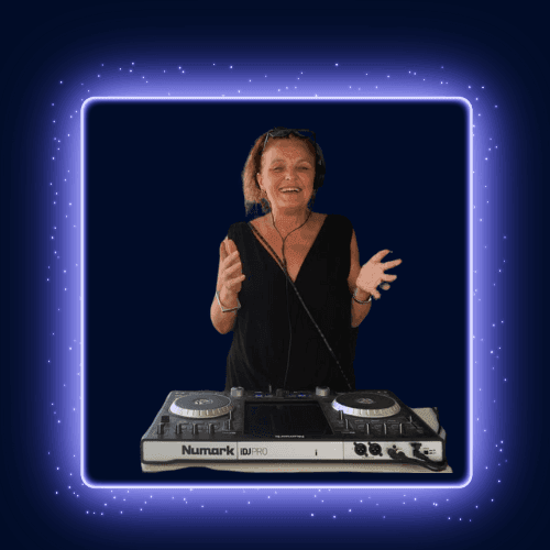 Person standing behind a Numark DJ controller, making hand gestures, with a dark glowing background.