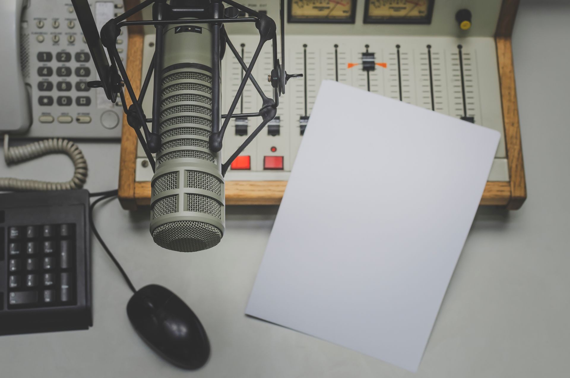 Radio station studio: microphone, sound mixer, phone on the table